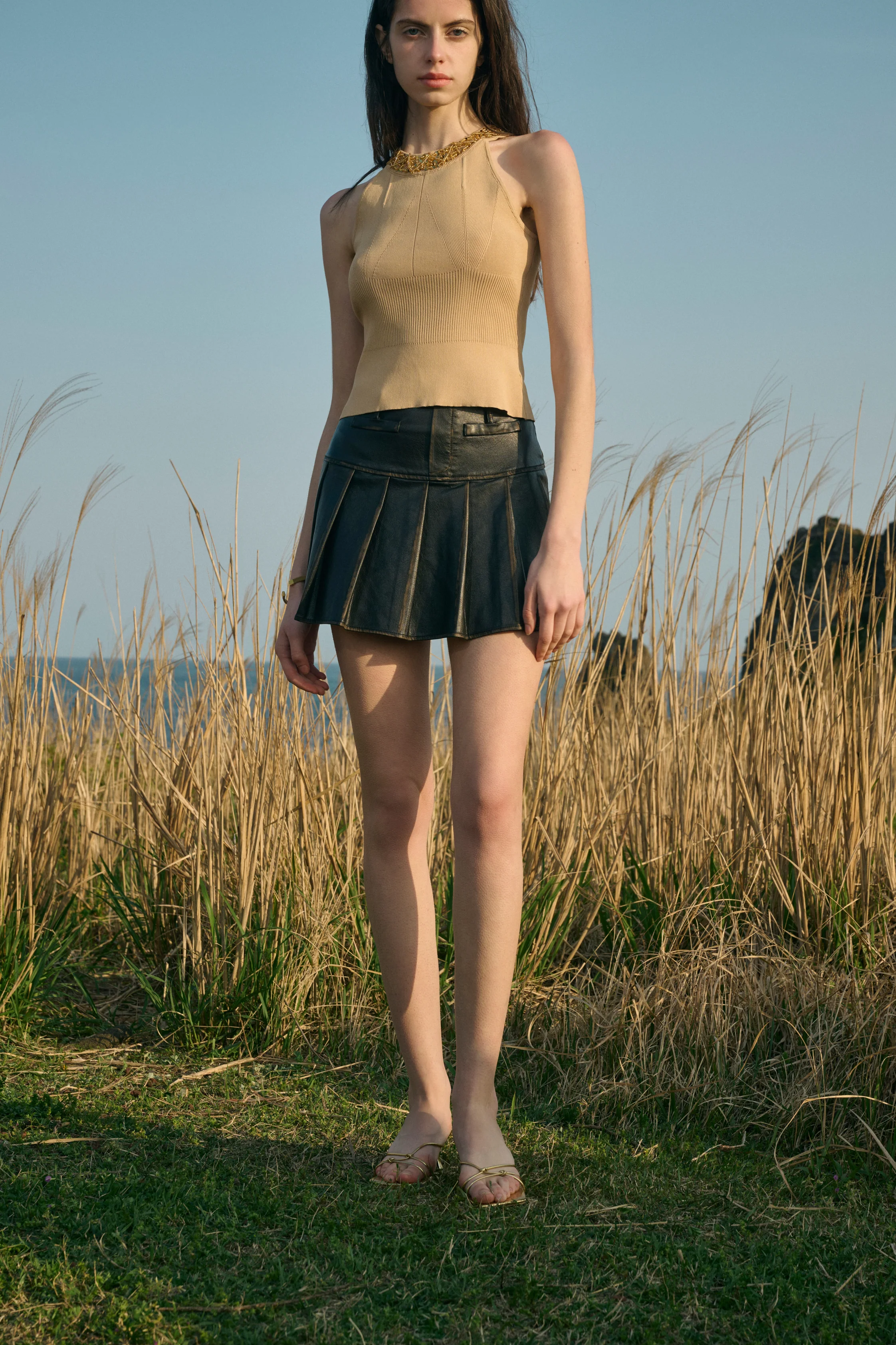 Distressed pleated mini skirt