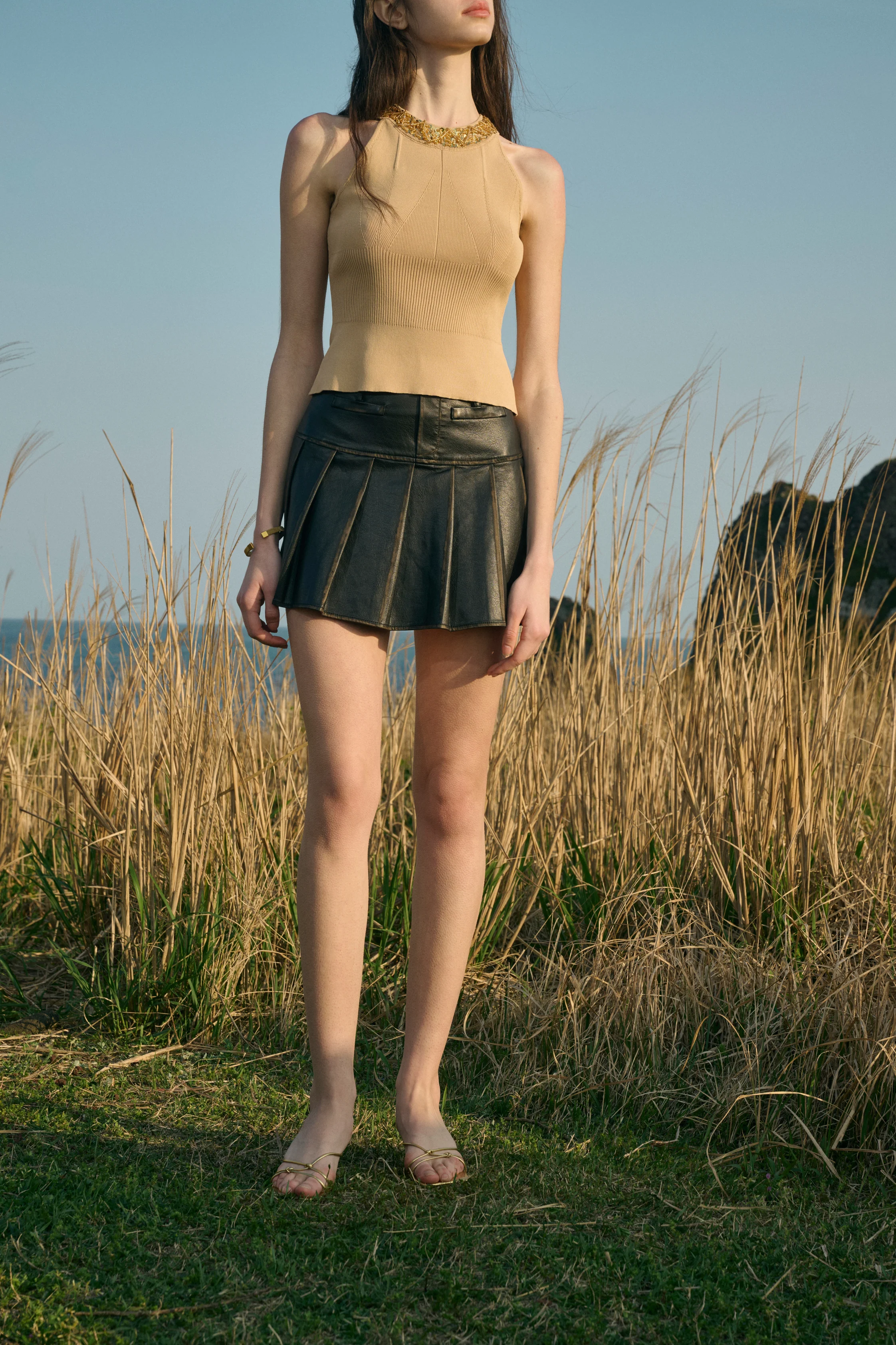 Distressed pleated mini skirt