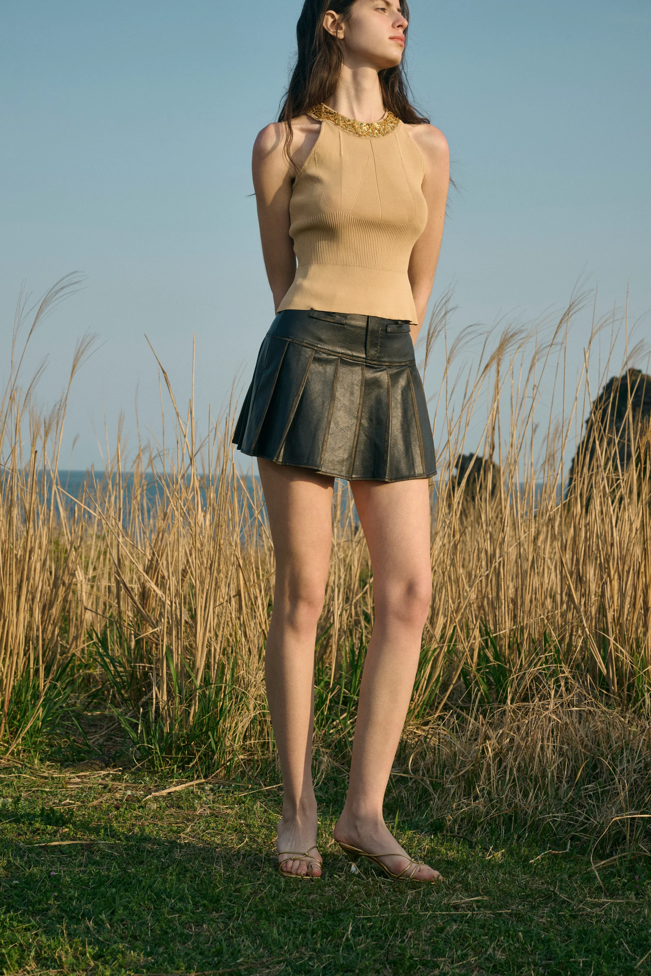 Distressed pleated mini skirt